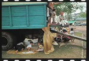 Vietnamese Refugees Using Truck as Shelter