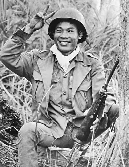 Vietnamese Soldier Smiling and Making the Peace Sign