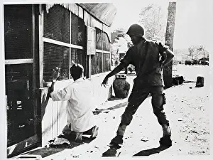 Vietnamese Soldier Stands Over Prisoner