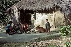 Vietnamese Villagers Outside Hut