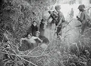 Vietnamese Woman and Children Emerging from Hole