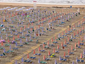 Closed Prints: View of the beach in the early morning with closed parasols and sun loungers