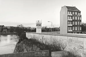 View over the Berlin Wall in 1985, detached house next to a watchtower adjacent to the inner German border