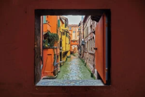 Medieval Gallery: View to the canal through square window, Bologna, Emilia-Romagna, Italy