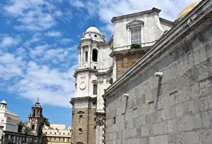 Andalucia Prints: Side view of the cathedral in front of the Iglesias Santiago Apostol Church in the Andalusian city of Cadiz