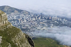 Aerial Collection: View of clouds rolling over downtown from Devils Peak, Table Mountain National Park, Cape Town