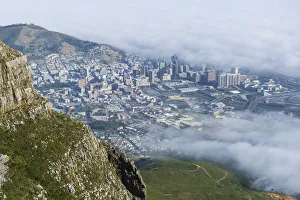 Aerial Collection: View of clouds rolling over downtown from Devils Peak, Table Mountain National Park, Cape Town