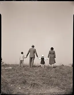 Conceptual Prints: Back View Family Holding Hands in Field
