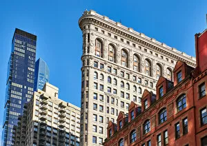 New York State Gallery: Side view of the Flatiron Building with surrounding buildings in the background against