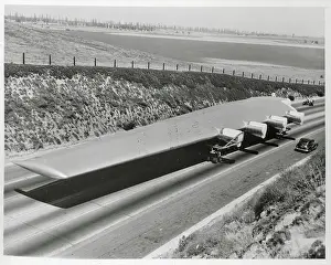 View of Howard Hughes Flying Boat Wing Next to Car