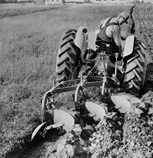 View of Man Using New Ford Tractor