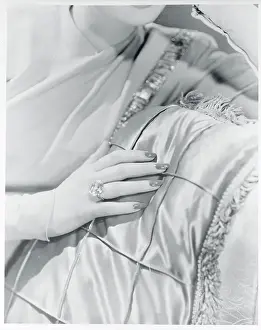 Prints of (Original Caption). Miss Lucille Ball wears an exquisite cushion-cut diamond engagement ring on the correct finger of her slim, feminine and expressive hands Behind the Laughter: Lucille Ball's Unseen Moments: View of Poised and Ring Worn Hand of Lucille Ball