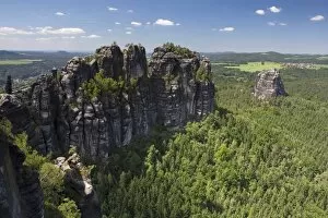 View of Schrammsteine ridge, jagged rock formation and Falkenstein rock, Elbe Sandstone Mountains, Saxony, Germany