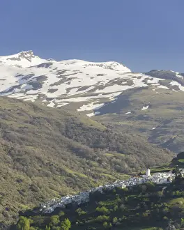 View over the town of Pampaneira towards the snow-capped Sierra Nevada Mountains, Pampaneira, Andalucia, Spain