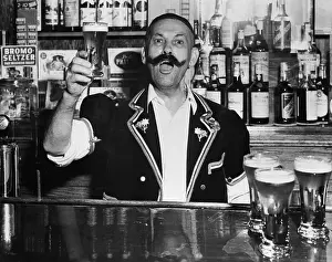 Bartender Prints: Vintage photograph of man working behind bar