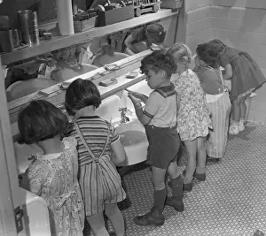 Hygiene Prints: Vintage photograph showing group of children (6-7) washing hands