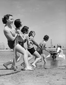 Sunshine Prints: Vintage photograph showing young women playing tug of war with motorboat