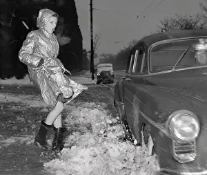 Splashing Prints: Vintage photograph of trendy young woman splashed over with semi melted snow
