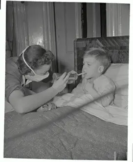 Visiting Nurse Checking Throat of Boy