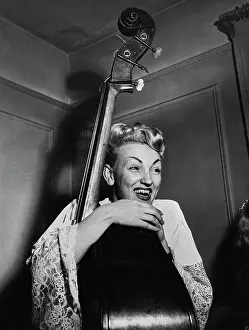 Prints of American jazz bassist Vivien Garry during a jam session at the home of the Café Society Downtown club pianist, Mary Lou Williams, New York, circa 1948 Timeless Moments: A Visual Journey Through History’s Defining Images: Vivien Garry