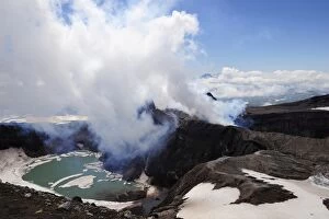 Volcanism Gallery: Volcanic crater with crater lake and a hot water vapour cloud, Gorely volcano