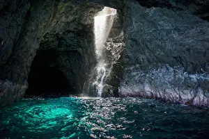 Glow Prints: Waiahuakua sea cave explored on boat tour of Na Pali Coast, Kauai, Hawaii, USA