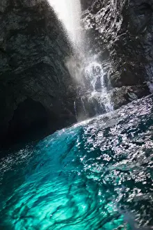 Glow Prints: Waiahuakua sea cave explored on boat tour of Na Pali Coast, Kauai, Hawaii, USA