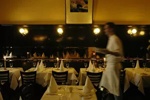 Waiter walking through restaurant, blurred motion