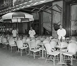 Waiters Standing at Empty Outdoor Cafe