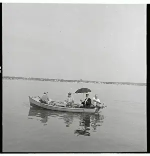 Walker Evans Sitting in Boat and Holding Umbrella