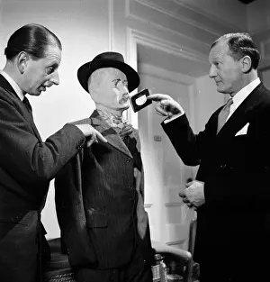 Prints of 28th February 1953: Actor Geoffrey Sumner being tutored in the pickpocket's art by former policeman Bob Fabian (right), for the Rank film Always A Bride' A Photographic Legacy: Wallet Picker
