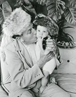 Walt Disney Holding His Grandson and Kissing His Cheek