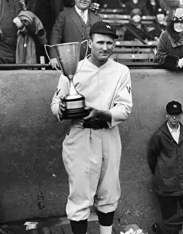 Prints of American baseball player Walter Johnson (1887 - 1946), pitcher for the Washington Sentors, poses with a trophy he has just been awarded, 1920s. (Photo by Hulton Archive/Getty Images) MLB Legends Art Prints: Top 10 Greatest Baseball Players of All Time: Walter Johnson Receives Trophy