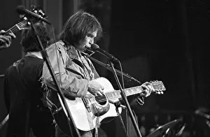 Prints of SAN FRANCISCO - NOVEMBER 25: Musician Neil Young performs on stage at The Band's The Last Waltz concert at Winterland Ballroom on November 25, 1976 in San Francisco, California Echoes of a Legend: Celebrating the Enduring Spirit of a Music Icon: The Last Waltz Concert