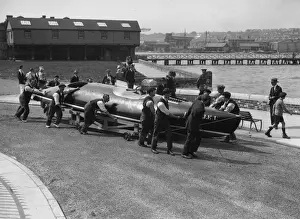 Prints of 31st May 1928: Estelle I the Saunder-Napier speedboat which owner Betty Carstairs is racing in the British International Trophy Race at Detroit being manhandled to a launch site at Cowes Topical Press Agency Prints: To The Water