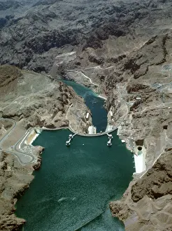 Prints of BOULDER CITY, NEVADA - July 05: Water overflows Lake Mead into side Spillways at Hoover Dam (NV) which recorded its Highest Water Level at 1 A Timeless Collection of Hoover Dam Photography: Water Overflows Lake Mead over Hoover Dam 1983
