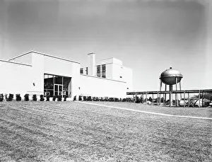 Belmont Prints: Water purification plant building, with water tower and well maintained grass lawn