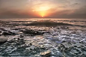 Kuwait Prints: Water washing over rocks on beach