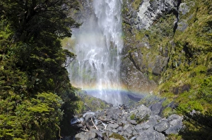 Waterfall with a rainbow, Devils Punchbowl Falls, Arthurs Pass, South Island, New Zealand Waterfall with a rainbow, Devils Punchbowl Falls, Arthurs Pass, South Island, New Zealand