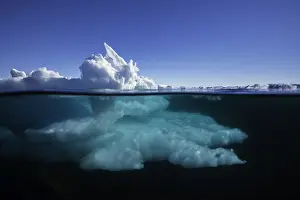 Above and below the waterline view of ice formations at the ice floe edge on a bright