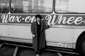 Prints of American-British comedian, actress and television presenter Ruby Wax poses before a coach with Wax on Wheels on the side of the vehicle, United Kingdom, 1989 Timeless Moments: A Visual Journey Through History’s Defining Images: Wax On Wheels