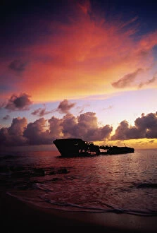 West Indies, Grand Cayman, Seven Mile Beach, ship wreck at sunset
