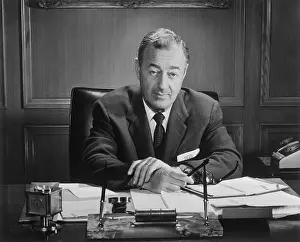 William J Prints: William J. Levitt Sitting at Desk