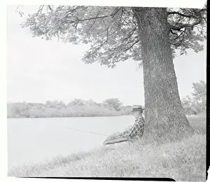 William Sexton Sitting on Bank and Fishing