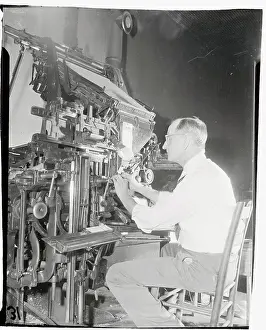 William Sexton Sitting and Working at His Press
