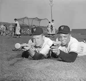 Willie Mays and Charlie Fowler Lying on Ground with Bats