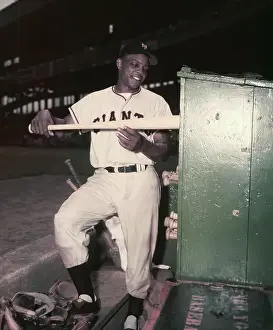 Willie Mays Placing a Bat into the Bat Rack