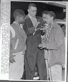 Willie Mays Signing an Autograph for Group of Fans