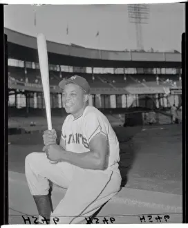Willie Mays Sitting on Ledge and Holding Bat