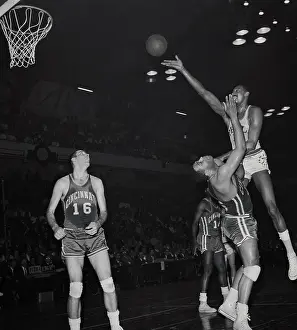 Wilt Chamberlain Jumping over Wayne Embry